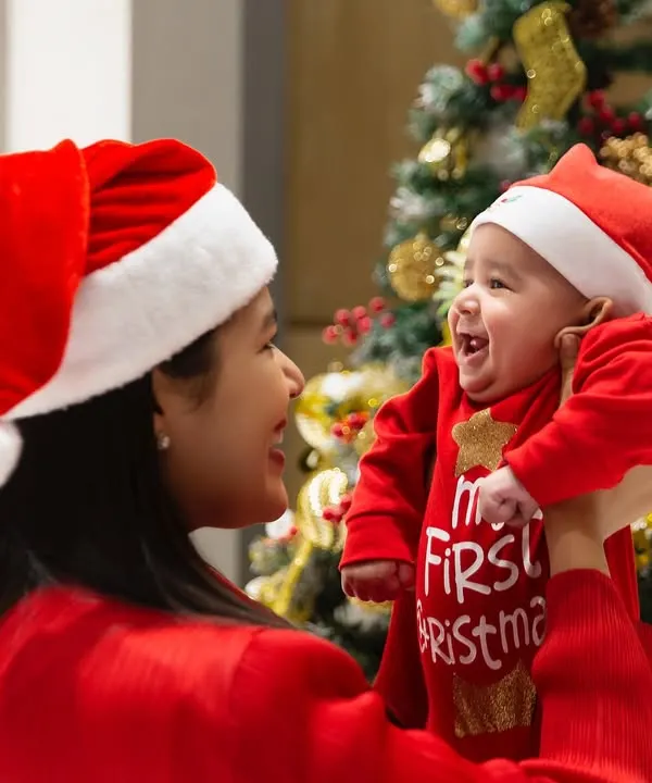 There is nothing more special than a baby's first Christmas. I love capturing the pure joy between a mother and her child, using the family's own festive tree as the perfect, personal backdrop for this unforgettable milestone.
