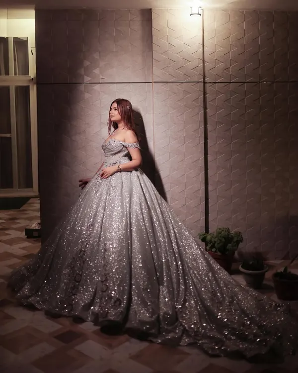 This is what fairytale dreams are made of. I designed this sparkling silver ball gown for those once-in-a-lifetime moments when you deserve to feel like absolute royalty. The endless train and off-shoulder detail make it a true showstopper for any grand event like a reception or pre-wedding shoot.
