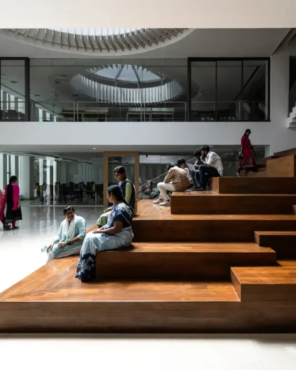 At the Sona University Library, we transformed a simple staircase into a dynamic social hub. This tiered wooden seating area encourages spontaneous interactions and collaborative learning, turning a circulation space into the heart of the campus. It is flooded with natural light from a large circular skylight, creating a warm and inviting atmosphere for students to gather, study, and connect.