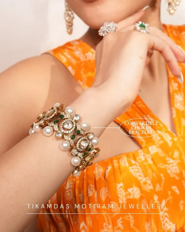 Why settle for one look when you can have two? This stunning polki, pearl, and emerald piece functions as both a wide statement bracelet and a magnificent choker necklace.