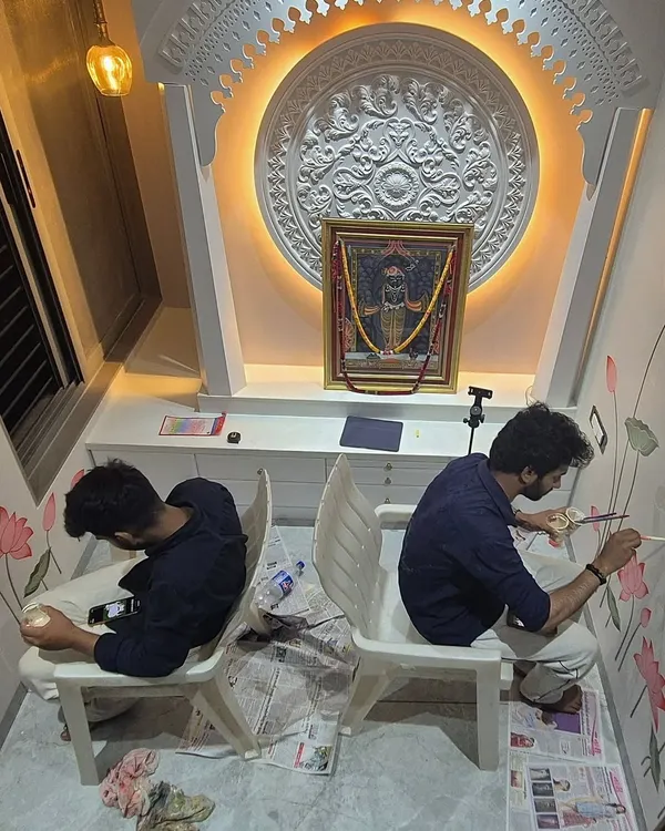 Here, my colleague and I are deep in the process of painting the lotus and Kamdhenu mural. Working in a sacred space requires focus and a meditative approach to each detail.