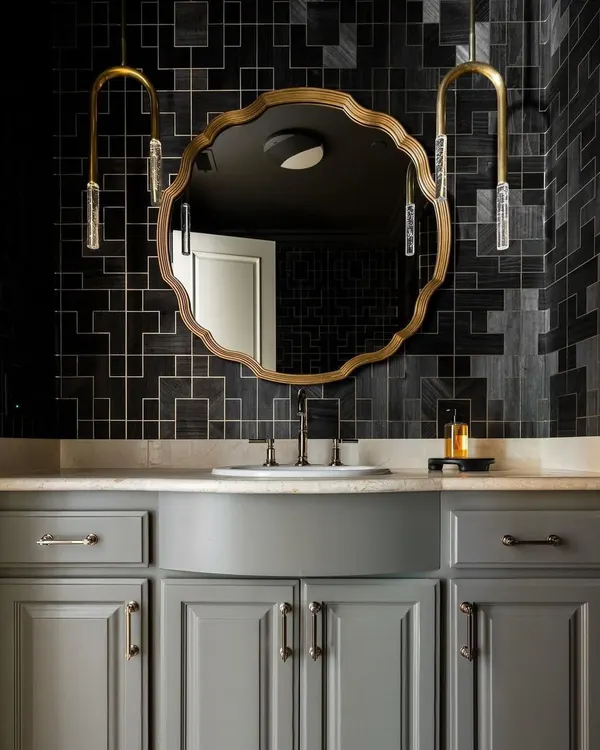 An atmospheric powder room featuring the 'Fretwork' collection from Phillip Jeffries. The elaborate geometric pattern in a bold charcoal shade adds a layer of moody sophistication and intricate detail to the space.