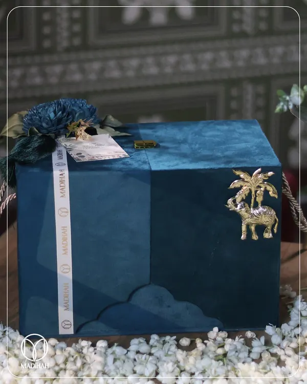 This is the art of bespoke corporate gifting. A deep blue velvet chest, adorned with a golden elephant motif and our signature ribbon, hints at the treasured experience within. It represents my commitment to creating gifts that are not just given, but remembered.