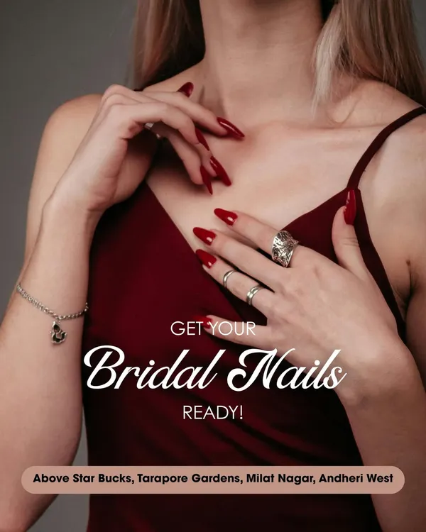 A promotional image showcasing classic, long red stiletto nails. This timelessly bold and confident look is perfect for a bridal party or any glamorous event.