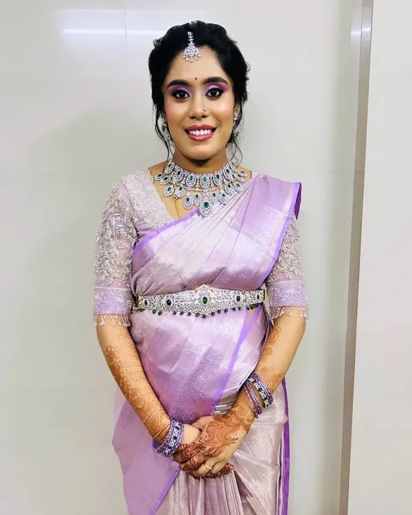 This bride wanted a modern yet elegant look for her semi-bridal event. We chose this sparkling American Diamond choker and matching oddiyanam (hip belt) to complement her beautiful lavender silk saree.