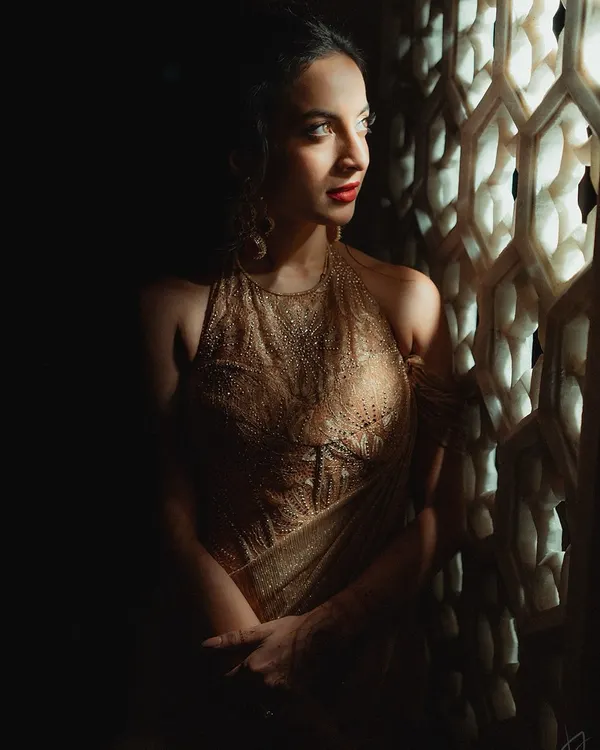 A vision in gold for her reception. Tessa was glowing with a bold red lip and golden shimmer on her eyes. This look is the perfect balance of radiance and grace, a glamorous end to the wedding festivities.