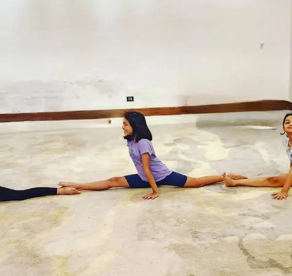 Three of our students perfectly synchronized in their splits. This image not only shows incredible flexibility but also the camaraderie and shared passion within our classes.