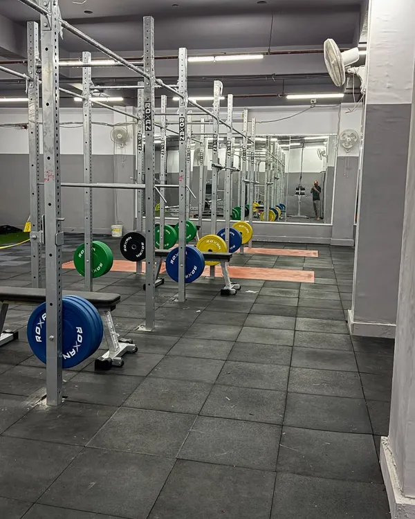 A look at the power racks and lifting platforms in my gym. This setup is the heart of our strength program, allowing for safe and effective execution of essential compound lifts like squats, presses, and deadlifts.