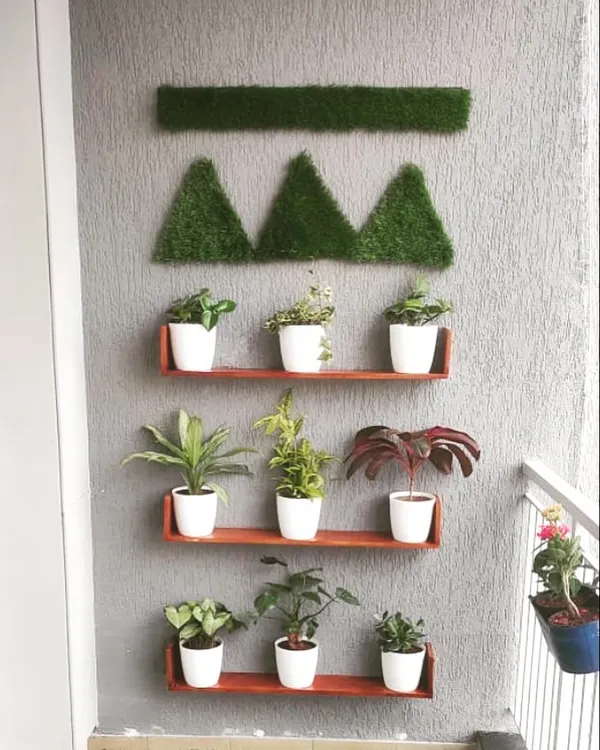 Elevate your plants with simple wall shelves. This setup creates a clean, organized display that turns your plants into a living art installation, complemented by geometric turf art on the wall.