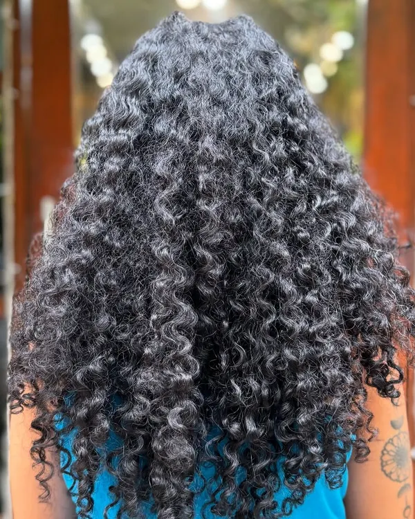 This client was ready for the big chop! We went from long, weighed-down hair to a short, voluminous style that lets her tight curls spring to life.