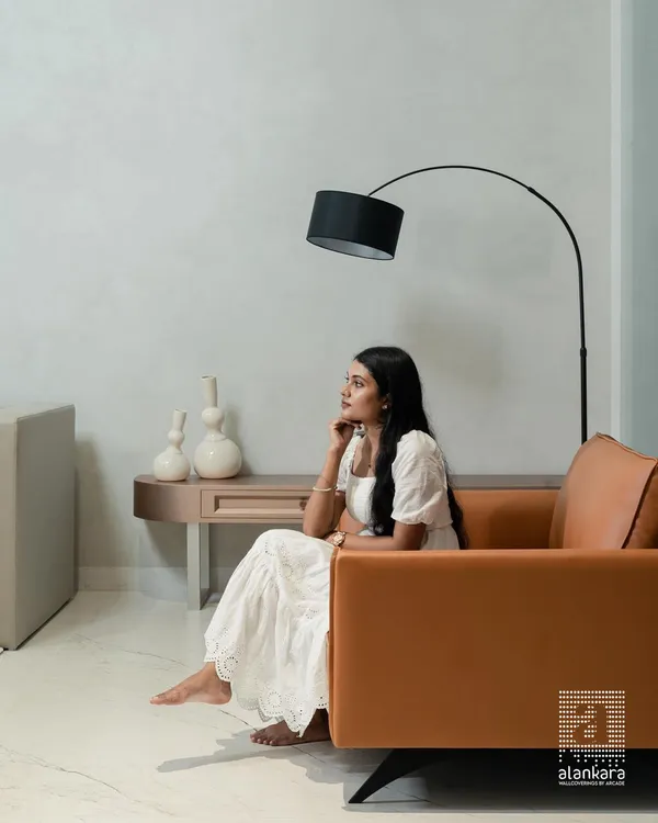 A moment of quiet contemplation in a space I designed for both elegance and comfort. The custom-made tan leather armchair provides a bold color accent against the neutral, textured walls, complemented by a modern arc floor lamp.