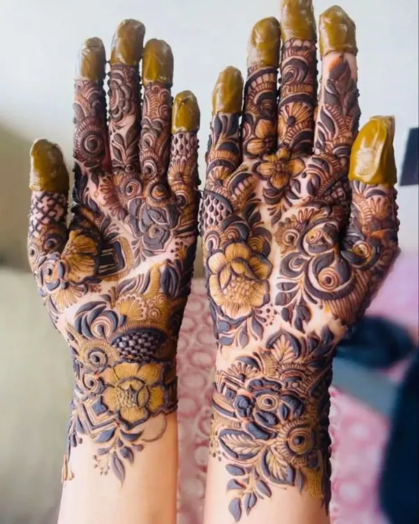 A classic full-hand bridal mehndi design, featuring a mix of floral elements, paisleys, and detailed finger work. This style provides that rich, heavy look many brides dream of for their wedding day.