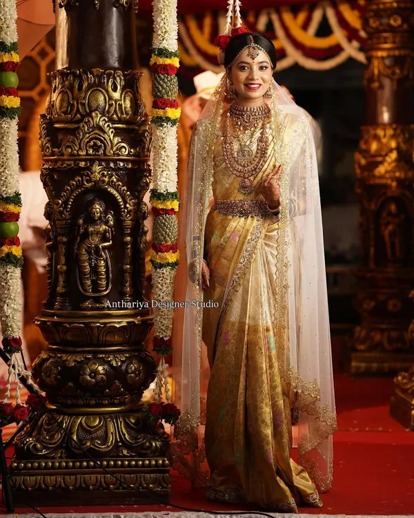This is what bridal dreams are made of. For my beautiful bride Monisha, we created this timeless golden Kanjivaram saree look for her muhurtham, complete with a custom hand-embroidered blouse and an elegant veil.