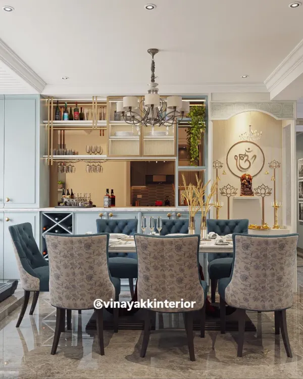 This design seamlessly integrates a pooja unit into the dining area. The elegant niche with an 'Om' symbol and traditional lamps provides a divine focal point without disrupting the modern aesthetic of the space.