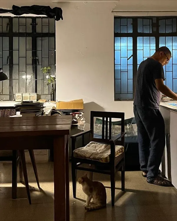 A quiet evening at the studio, where an artist works late into the night, with Julie the cat keeping watch. Our space nurtures both collaboration and the solitude required for deep creative work.