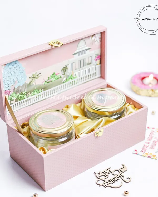 This elegant pink box, with its intricate 3D palace design, opens to reveal two jars of premium dry fruits. It's a perfect example of how I blend traditional motifs with contemporary luxury for a memorable Diwali gift.