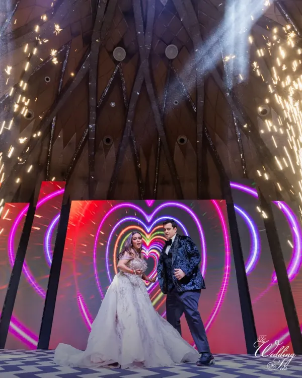 A couple's performance on a grand stage with a heart-themed LED background and dramatic cold pyrotechnics. This is how we create show-stopping moments.
