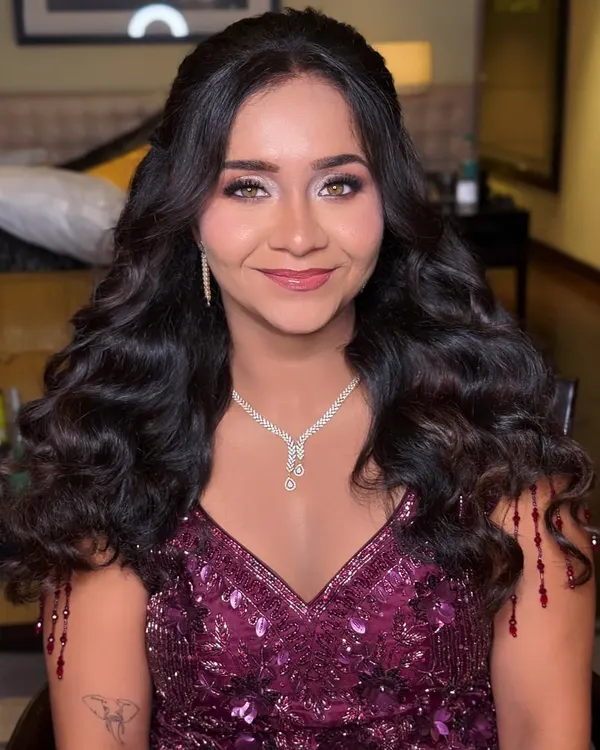 A beautiful reception look featuring soft, voluminous curls. This half-up, half-down style is perfect for showing off long hair while keeping it elegantly styled.