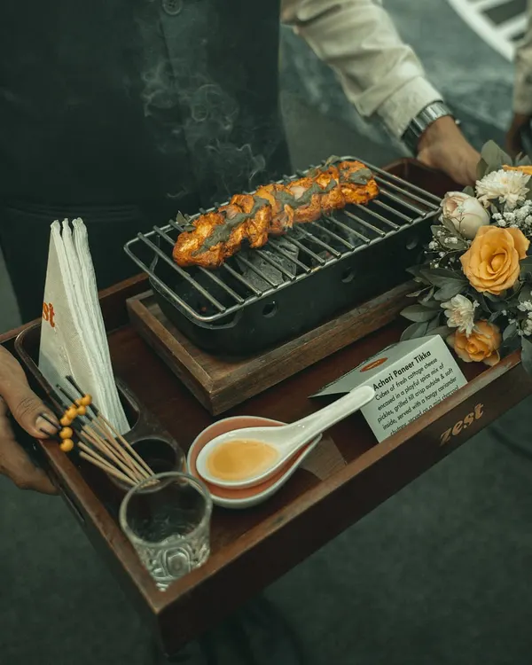 We believe food should be an experience. Here, our Keshri Paneer Tikka is served on a personal charcoal grill, smoking with spices right at the table. It's this attention to detail and a touch of drama that we bring to every event.