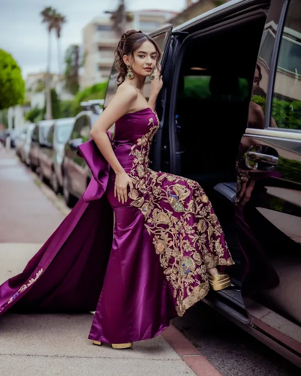 The arrival. Anushka Sen stepping out for the Cannes red carpet in a custom-designed purple gown featuring a structured bow and an elegantly embroidered train. This celebrity red carpet styling was all about creating a memorable debut.