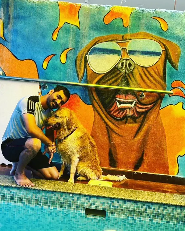 Bruno and his human sharing a quiet moment by the pool. Our space is designed for pet parents to bond with their furry kids.