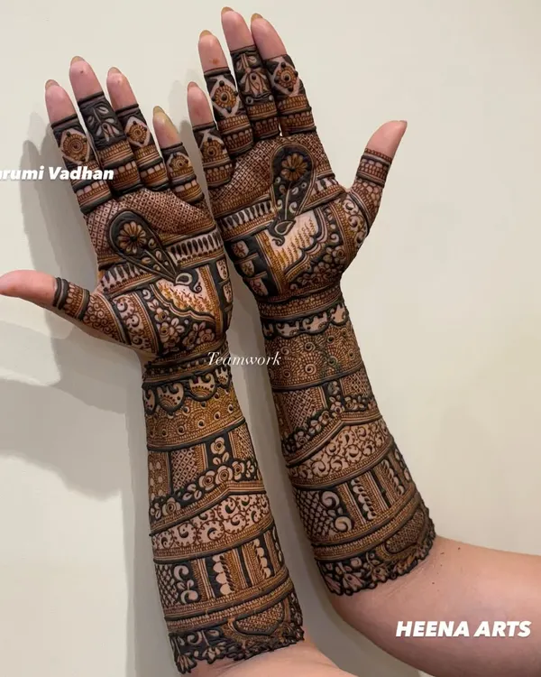 A gorgeous full-arm mehendi for the groom's sister. The design is intricate and celebratory, perfect for a close family member.