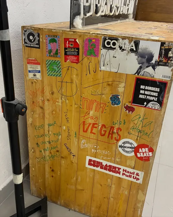 The original, custom-built Boxout.fm DJ booth, covered in stickers and signatures. This piece of furniture holds years of history and represents the community we've built.