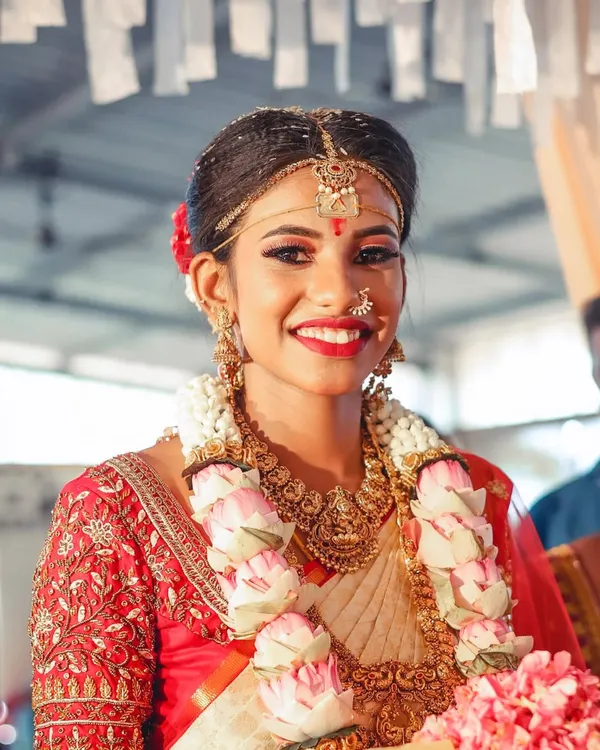 This is the radiant smile I love to see. A close-up of my bride Varsha's muhurtham makeup, focusing on a flawless base and eyes that shine with happiness.