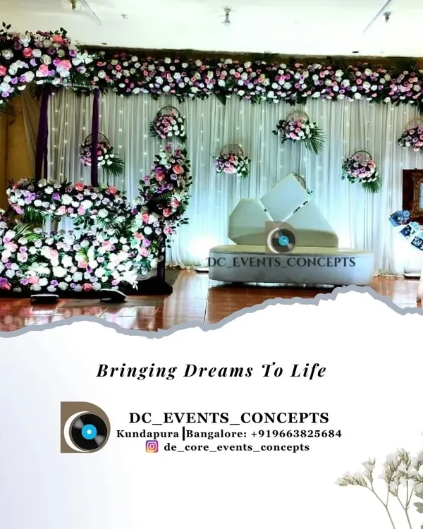 A dreamy cradling ceremony setup featuring a crescent moon floral arch. The soft color palette, hanging flower baskets, and a personalized photo easel create a beautiful and serene atmosphere.