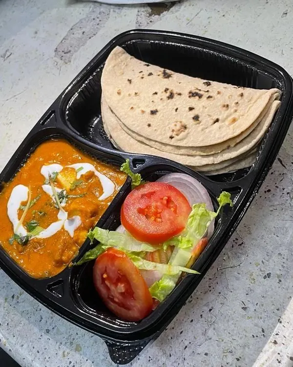 A delicious Shahi Paneer meal, complete with a creamy tomato-based gravy, served with soft rotis and a fresh garden salad. This is a rich and satisfying option for your daily lunch.