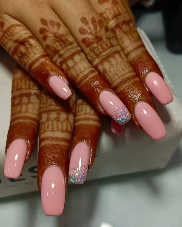 A beautiful set of peach-toned gel extensions, perfect for a modern bride. I've added a delicate silver glitter accent nail to complement the solid colors, creating a look that is both elegant and celebratory, especially when paired with intricate mehendi.