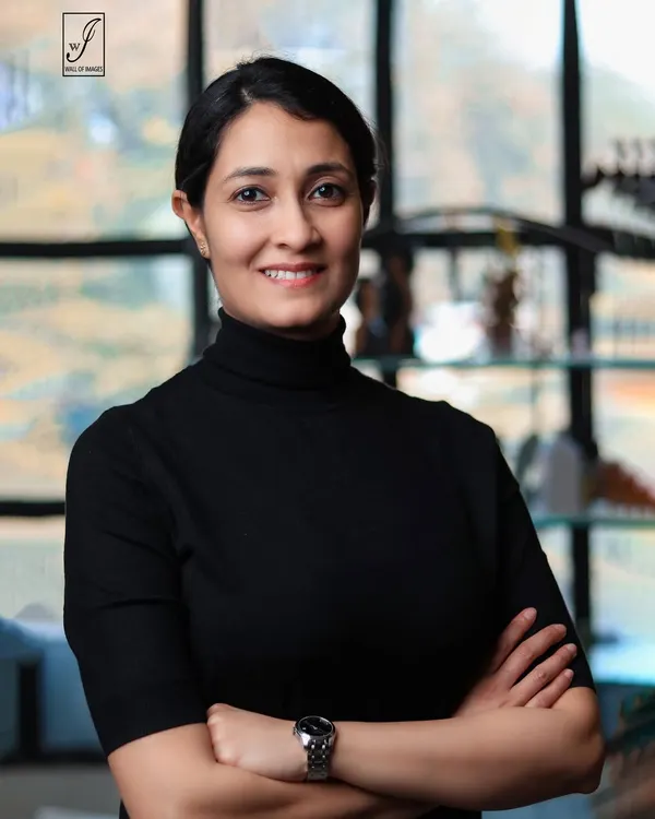 A classic professional headshot with a friendly and confident expression. The clean, out-of-focus background keeps the attention on the subject.