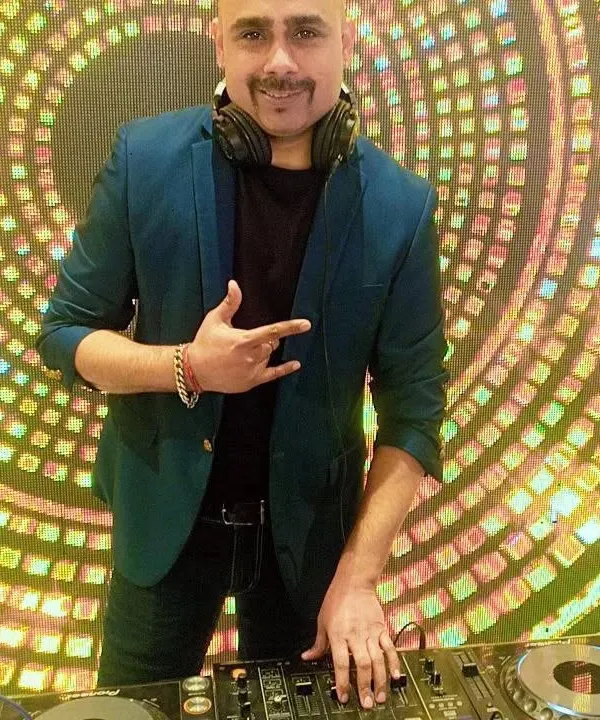 A clear, happy shot of me at my Pioneer DJ console, ready to get the party started. I believe a DJ's energy is just as important as the music they play.
