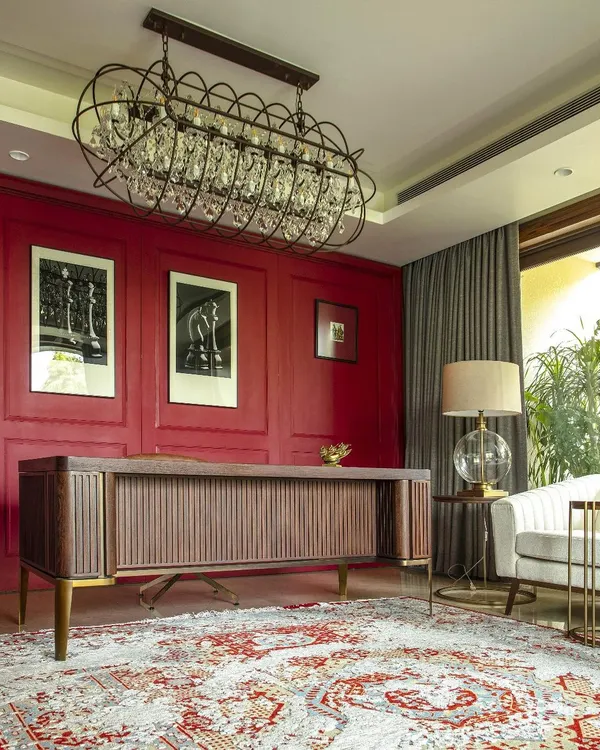 For our Barkat residence, we designed this bespoke desk and paired it with a bold red wall to create a powerful and inspiring home office. Each piece is crafted in collaboration with local artisans to be both functional and a work of art.