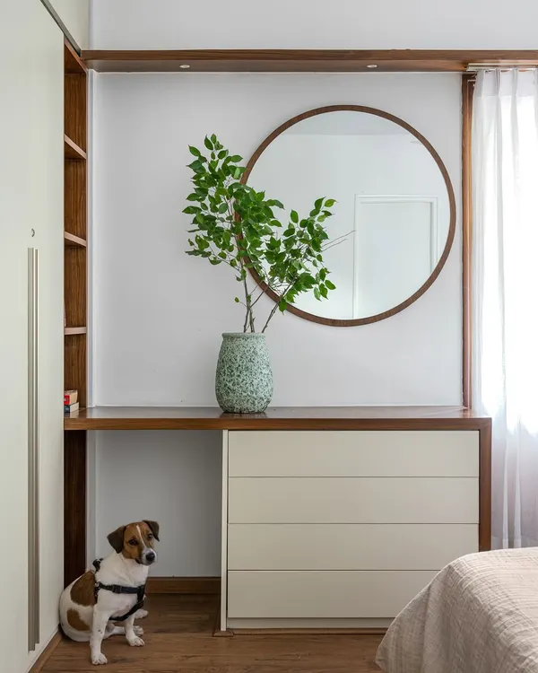 A detail from our 'Pepper and Coffee' duplex renovation, featuring a custom dresser and a round mirror. This project was an ode to the family's beloved pet, who you can see here.