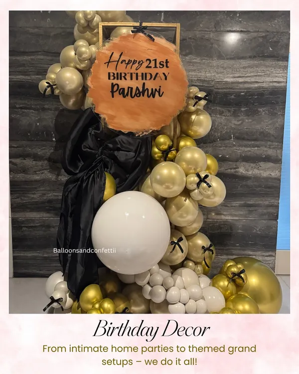A chic and modern decor piece for a 21st birthday. I used a sophisticated palette of gold, black, and white balloons, with a custom-painted acrylic sign for Parshvi's celebration.