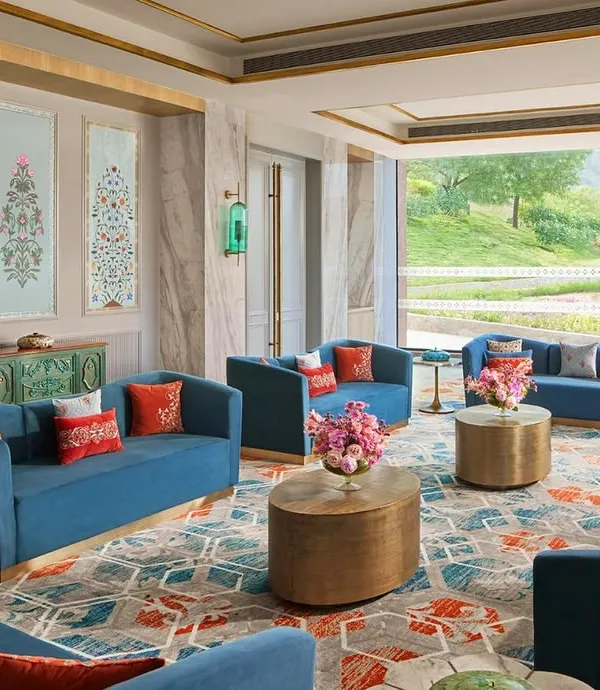 This living space at the Taj Devi Ratn Resort & Spa is a sanctuary I designed in the Pink City. The vibrant blues of the custom upholstery and the intricate patterns of the hand-knotted carpet come together to create an atmosphere of quiet luxury, where traditional Indian elements breathe within modern elegance.