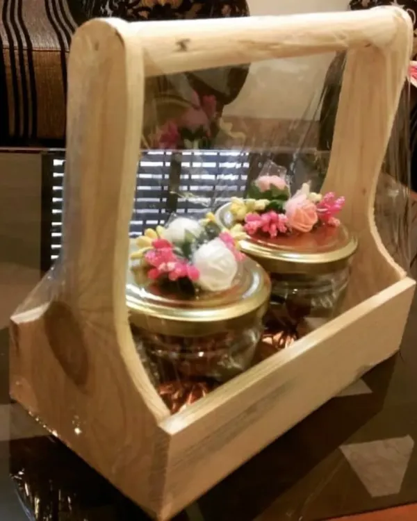 This handcrafted wooden box with a handle is one of my signature items. It can be filled with customizable chocolate jars and is perfect for any occasion.