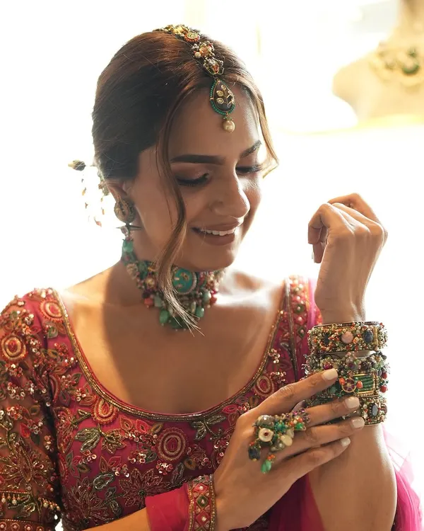 Inspiring brides, one collaboration at a time. A behind-the-scenes shot from a creative shoot, pairing a Ridhi Mehra fuchsia lehenga with eclectic jewelry from Purab Paschim.