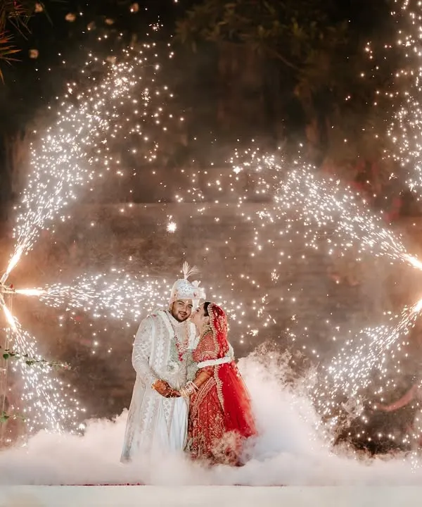 We believe in creating moments that feel like magic. Here, the couple is framed by a spectacle of cold pyros and ethereal smoke, turning their Varmala into a breathtaking memory against the night sky. This is the heart of what we do: turning wedding dreams into cinematic reality.