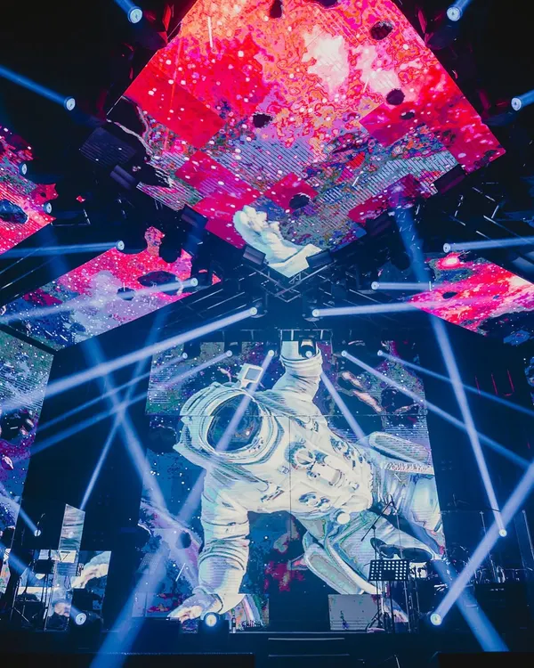 We rolled out the entire universe for this one. A massive astronaut figure floats above the stage, surrounded by cosmic visuals and laser beams, showcasing our commitment to boundary-pushing production design.