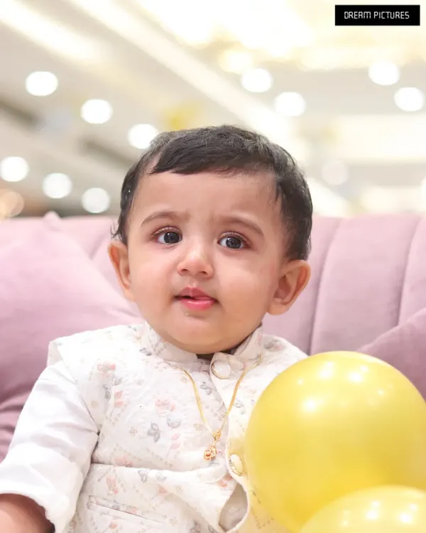 A beautiful, clear close-up portrait of a baby boy. His innocent expression and bright eyes are the focus of this simple and classic baby photo.