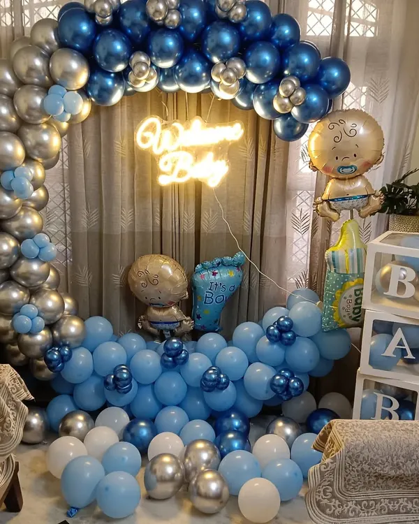 A complete 'Welcome Baby' decoration package for a home. This setup features a full circular balloon arch in metallic silver and blue, a neon sign, 'BABY' blocks, and several themed foil balloons to celebrate the new arrival.
