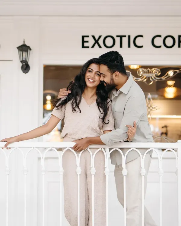 A candid moment of laughter on the balcony of a chic cafe. This type of shoot is perfect for couples who want a relaxed, modern, and stylish pre-wedding session.