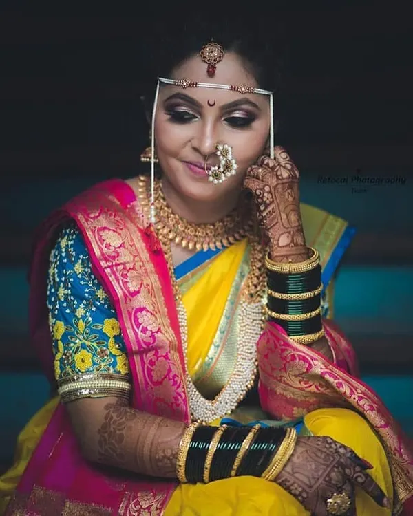 A classic Maharashtrian bridal look is all about the details. I love perfecting every element, from the smoky eyes and traditional 'mundavalya' forehead ornament to the iconic 'nath' nose ring, ensuring my bride feels like royalty on her special day.