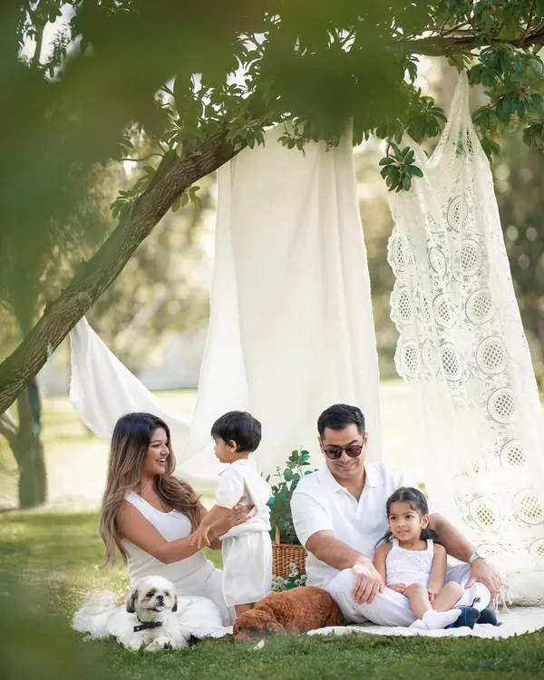 A beautiful family enjoying a picnic under the trees. I love capturing these candid moments of interaction and play during our outdoor sessions.