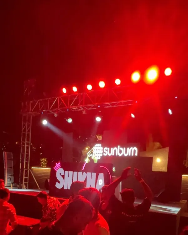 The stage is my home. A blurry but memorable shot from my set at Sunburn Festival, with the iconic logo lit up behind me.