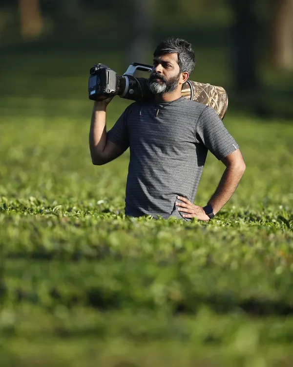 Out in the field, surrounded by the tea gardens of the Western Ghats. Carrying a heavy lens is part of the job, but the results are always worth the effort.