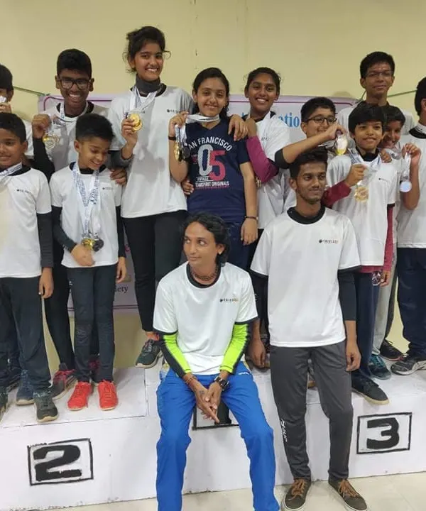 A proud moment with my young champions on the winner's podium. This image celebrates the multiple medals won by our shooters, showcasing the depth of talent nurtured at my academy.