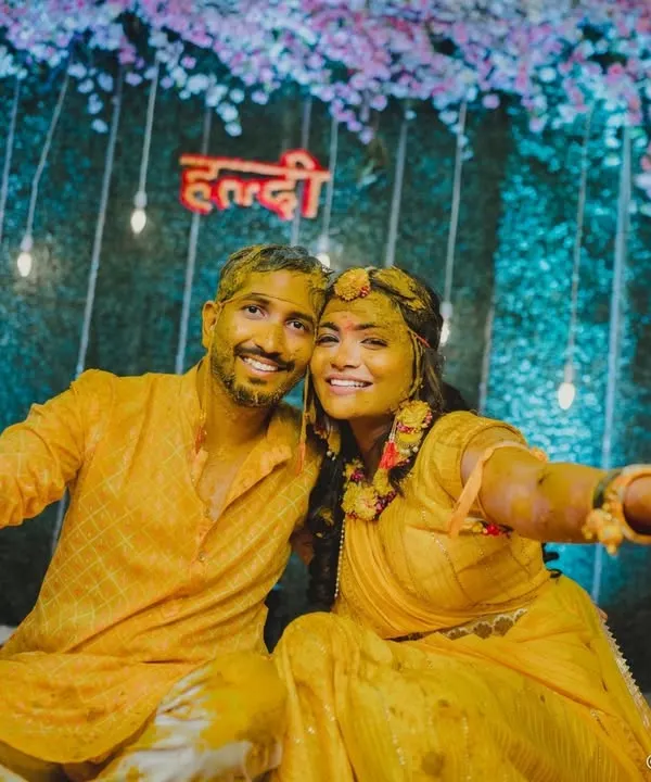 A fun-filled shot of the couple covered in turmeric paste, posing happily after their Haldi ceremony.